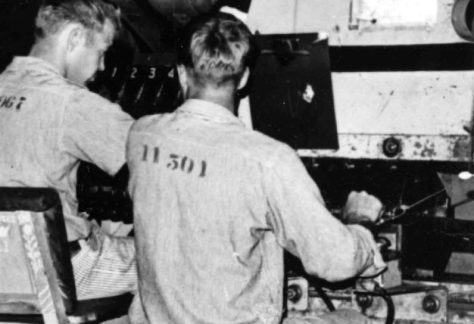 Work inside Shirt Factory Building - two men working in License Plate Factory.