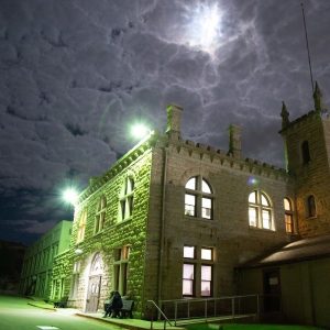 Old Idaho Penitentiary entrance at night.