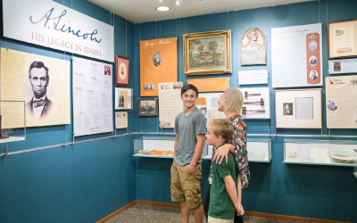 Adult and Kids Looking at Idaho State Archives Exhibit