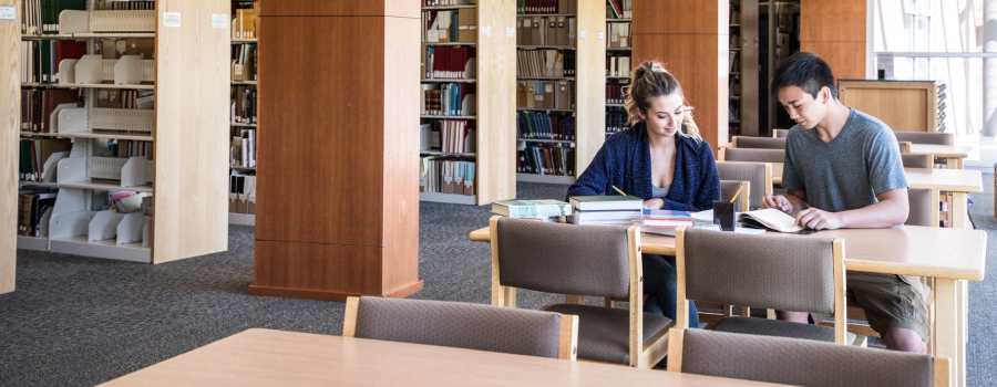 Two People Sitting at a table is the Idaho State Archives