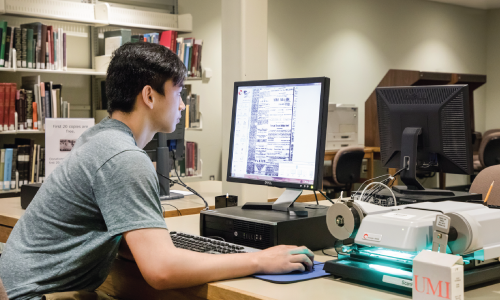 Student Using an Archives Research Microfilm Reader