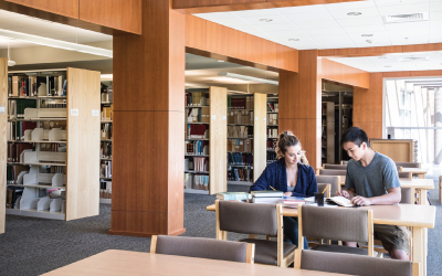 Two People Sitting at a table is the Idaho State Archives