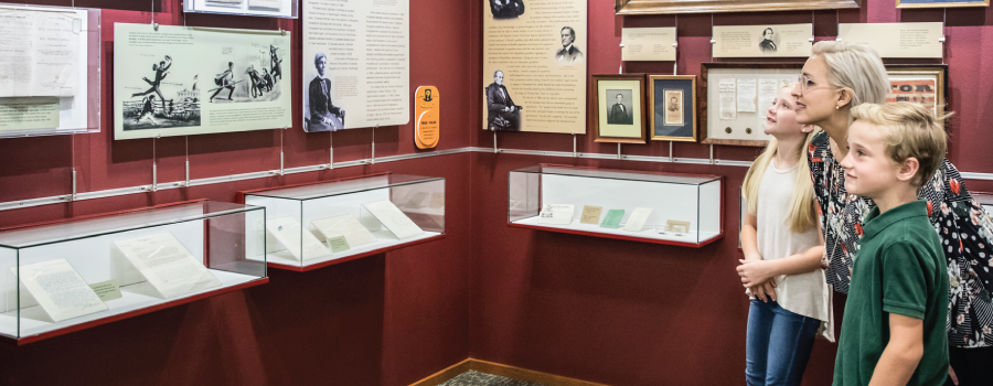 Family Looking at Idaho State Archives Exhibit