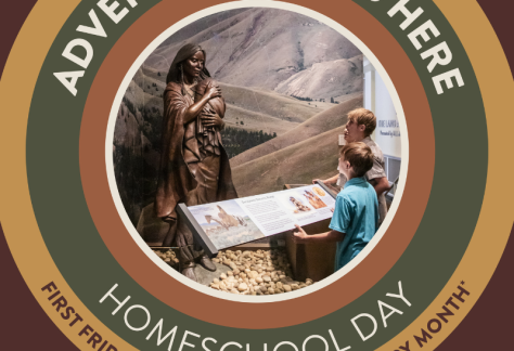 Children standing in front of a bronze Sacajawea sculpture inside the Idaho State Museum.