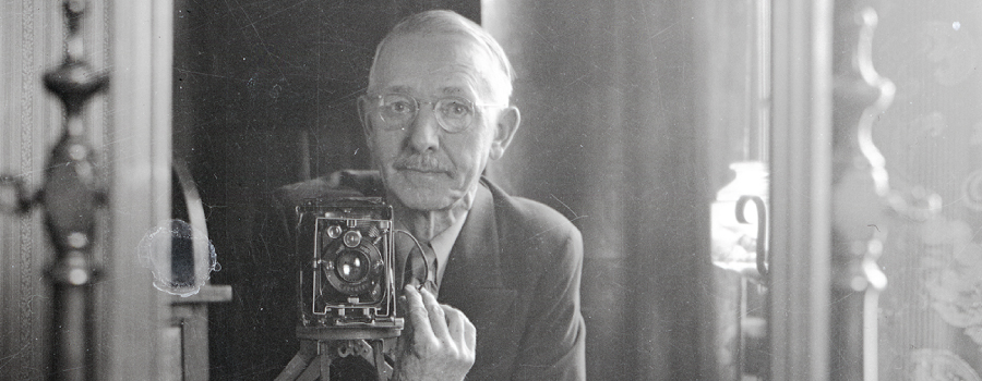 Black and White; Man Holding an Old Camera