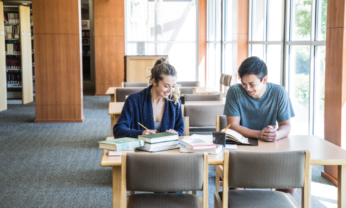 Two People Sitting at a table is the Idaho State Archives