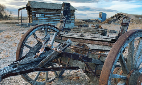 Rusted farming equipment sitting unused in a field